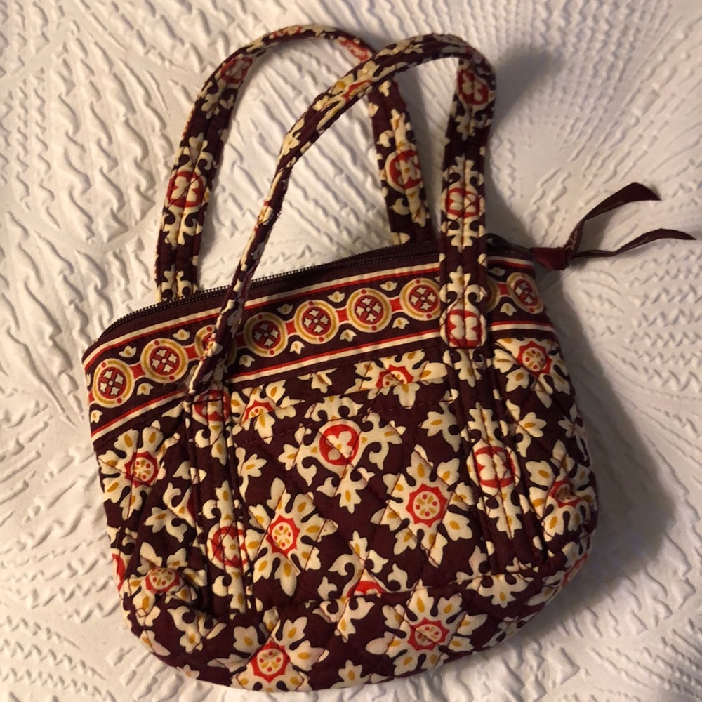 Vera Bradley mini clutch with zipper.